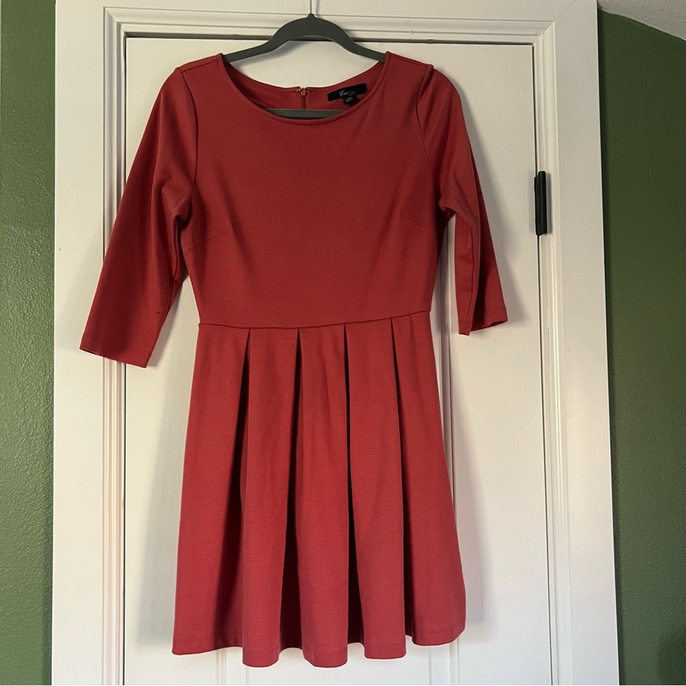 Rose colored knit dress with pleated skirt and 3/4 sleeves